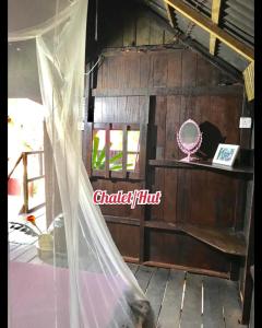 a room with a veil and a mirror and a window at Harrera Perhentian, Long Beach in Perhentian Island