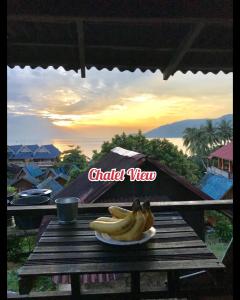 a bunch of bananas on a plate on a table at Harrera Perhentian, Long Beach in Perhentian Island