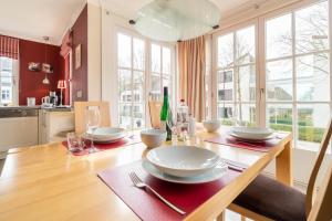 a dining room table with plates and glasses on it at Ferienwohnung Seeschwalbe in Südstrand