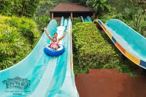 a young girl riding a water slide at a water park at Sunway Lost World Hotel in Ipoh