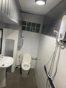 a bathroom with a toilet and a sink at Momento Resort in Pattaya South