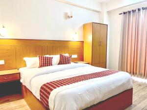 Voodi või voodid majutusasutuse Madhuban Hotel toas