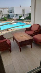 a patio with a table and chairs and a pool at Criss Resort-Naama Bay in Sharm El Sheikh
