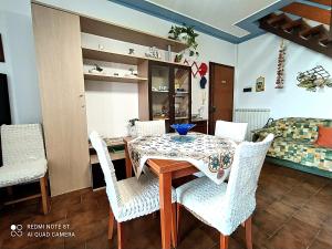 a dining room with a table and chairs at Tra Puccini ed il mare in Torre del Lago Puccini