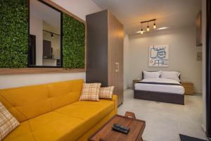 a living room with a bed and a couch and a bedroom at Travelholic Residence Golden Gates in Cairo