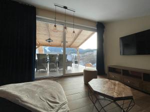 a living room with a view of a dining room at Totina Apartments in Závažná Poruba