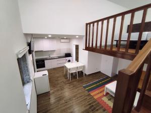 a living room with a staircase and a kitchen at Quinta do Gestal - Soutelo in Vila Verde