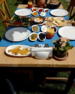 a wooden table with plates of food on it at Gocek Unlu Hotel in Göcek