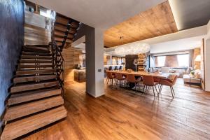 a dining room and kitchen with a staircase in a house at Cocoon Deluxe - Luxury Chalet in Chamois