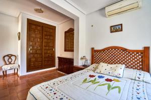 a bedroom with a bed with flowers on it at Espanhouse Villa in Ciudad Quesada for 4 in Ciudad Quesada