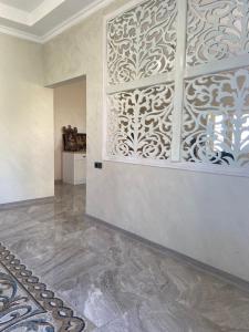 a living room with a wall with a laser cut pattern at KEMO house in Batumi