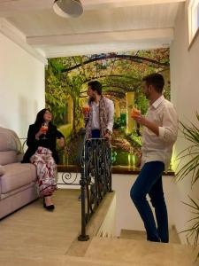 a group of people standing in a room with drinks at La Primavera in Anacapri