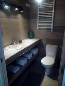 a bathroom with a sink and a toilet and a sink at Casa La Cabiana in Rotella +37 photos