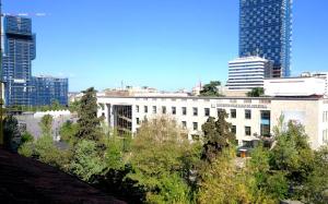 a view of a city with tall buildings and trees at Central Loft in Tirana +5 photos