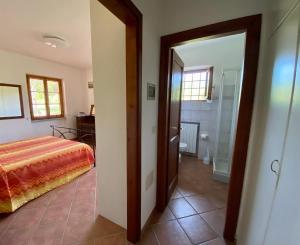 a bedroom with a bed and a walk in shower at Podere Il Ritorno in Portoferraio