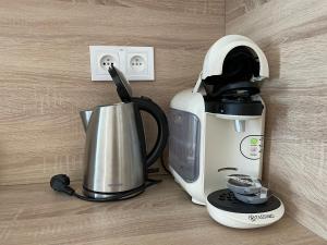 a coffee maker and a blender on a counter at Totina Apartments in Závažná Poruba