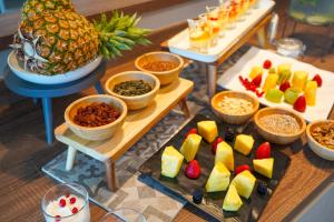 una tabella ricoperta da molti tipi di alimenti diversi di Hotel Alexandra - Beach Front -XXL Breakfast & Brunch until 12 30pm a Misano Adriatico