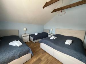 a bedroom with two beds and two night stands at Totina Apartments in Závažná Poruba