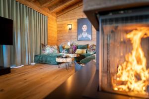 a living room with a couch and a fire place at Mountain Chalet R in Berwang