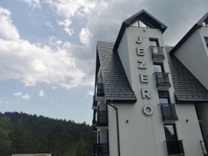 a building with a sign on the side of it at Divčibare Jezero apartman 25 in Divčibare