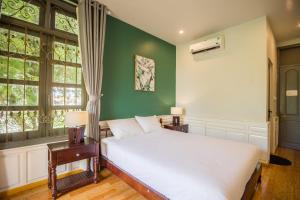 Giường trong phòng chung tại Thi Boutique Villa