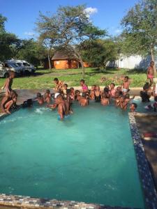 a group of people sitting in a pool of water at Lituba Lodge 