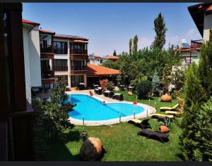 a large swimming pool in the yard of a building at Venus Hotel in Pamukkale