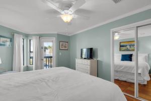 a bedroom with a bed and a mirror at Blue Paradise in Destin +26 photos