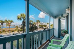 a balcony with two chairs and a view of the beach at Blue Paradise in Destin