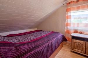 a bedroom with a purple bed in a room at Tourist Apartment in Klaipėda