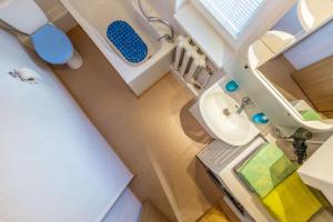 a small bathroom with a sink and a toilet at Tourist Apartment in Klaipėda +12 photos