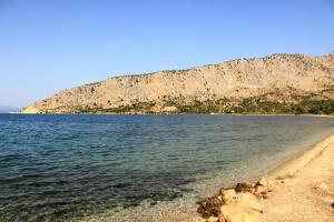 a body of water with a mountain in the background at Asteri Apartments Mytikas 2-Bedroom Seaview Courtyard in Mitika