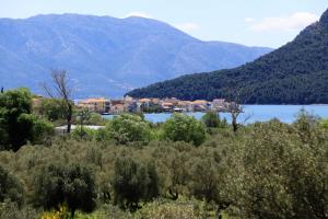 a town on a lake with mountains in the background at Asteri Apartments Mytikas 2-Bedroom Seaview Courtyard in Mitika