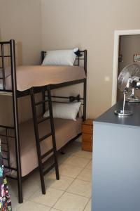 a room with a bunk bed with a desk at Asteri Apartments Mytikas 2-Bedroom Seaview Courtyard in Mitika
