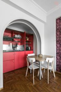 a dining room with a table and red cabinets at Rustique, Nilie Hospitality MGMT in Thessaloniki