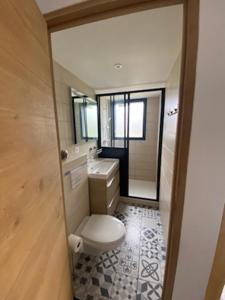 a bathroom with a toilet and a sink and a mirror at L'Etauline à deux pas de l'océan in Étaules
