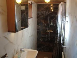 a bathroom with a sink and a shower at 2 room apartment in Ystad