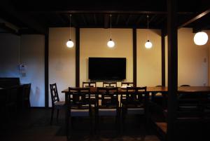 comedor con mesa y TV de pantalla plana en Kanazawa Hitomuneyado Kaisen - Vacation STAY 94227v en Kanazawa