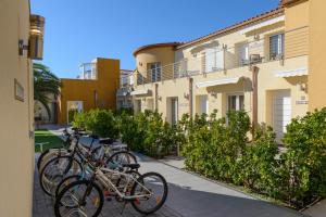 a row of bikes parked next to a building at La Vida Sin Limites EMP in Empuriabrava +132 photos