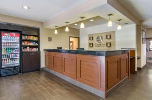 a bar in a restaurant with a drink refrigerator at Comfort Inn & Suites Near Worlds of Fun in Kansas City