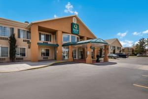 a hotel with a gas station in a parking lot at Quality Inn & Suites Airport West in Salt Lake City