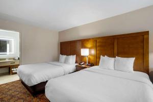 two beds in a hotel room with white sheets at Comfort Inn Downtown Nashville - Music City Center in Nashville