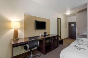 a hotel room with a television and a bed at Sleep Inn & Suites Cave City in Cave City