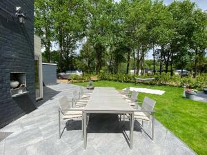 a table and chairs sitting on a patio at Strandhuisje Ermerzand in Erm