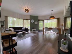 a living room with a couch and a table at Strandhuisje Ermerzand in Erm