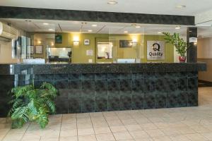a lobby with a black counter in a building at Quality Inn & Suites in Vernon