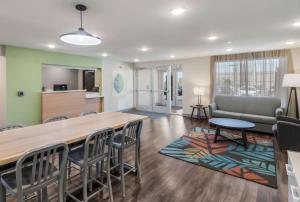 a living room with a large table and chairs at WoodSpring Suites Round Rock-Austin North in Round Rock