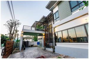 a house with a walkway in front of it at Richly's​ Pool​ villa​@Phitsanulok​ in Phitsanulok