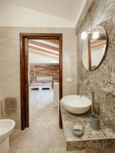 a bathroom with a tub and a sink and a mirror at Agriturismo Tenuta Carrino in Porto Cesareo