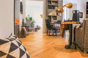 salon z drewnianą podłogą i stołem w obiekcie Valsabbion Deluxe City Suite w Puli